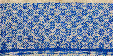 A fragment of the texture of a white-blue tablecloth made in the 1960s in Ukraine. Traditional national ornament.