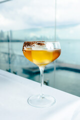 cocoa liqueur, cocoa cocktail with rum against the background of the sea
