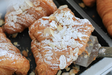 Almond Croissant pastry Bakery homemade. Traditional French breakfast tray with gold and crispy croissants.