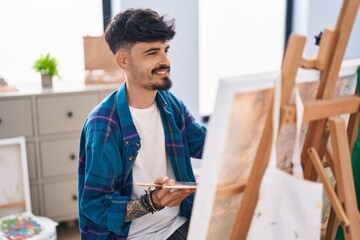 Young hispanic man artist smiling confident drawing at art studio
