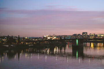 Naklejka premium Reflection of city in river in downtown Portland Oregon at sunset. 