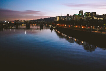 Fototapeta premium Reflection of city in river in downtown Portland Oregon at sunset. 