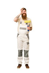 Adult painter man full body cut out isolated excited keeping ok gesture on eye.