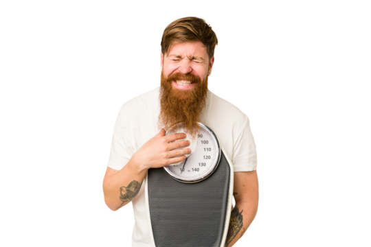 Adult redhead man with long beard holding a scale isolated cut out laughing and having fun.