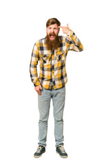 Young adult redhead man with a long beard standing full body isolated showing a disappointment gesture with forefinger.