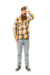 Young adult redhead man with a long beard standing full body isolated forgetting something, slapping forehead with palm and closing eyes.