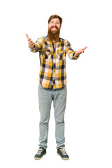 Young adult redhead man with a long beard standing full body isolated showing a welcome expression.