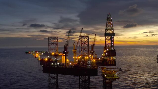 Aerial view of offshore jack up drilling rig during sunset - oil and gas industry
