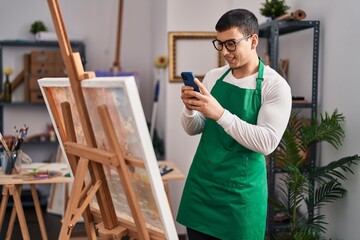 Young man artist make photo to draw by smartphone at art studio