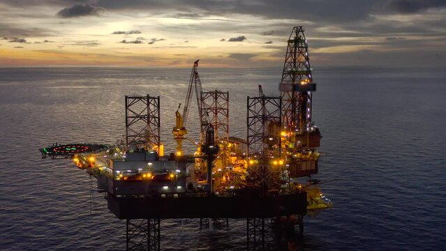 Aerial view of offshore jack up drilling rig during sunset - oil and gas industry
