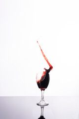 Explosion of wines in a glass, with a white background and in studio