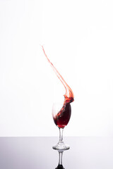 Explosion of wines in a glass, with a white background and in studio