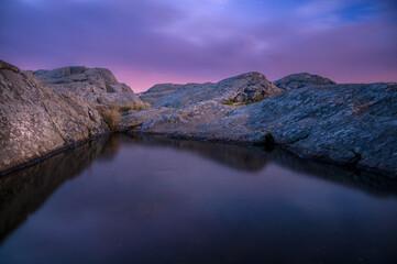 A small reflecting puddle at the summit of Mount Monadnock at sunrise