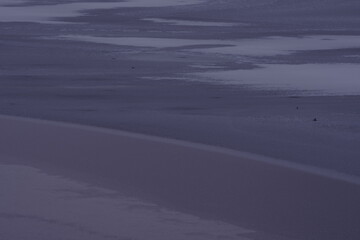 Landscape photo of frozen lake in winter. The ice gives an artistic impression. Winter morning photo. dark impression.