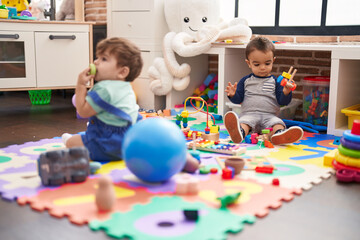 Two kids playing with toys at kindergarten