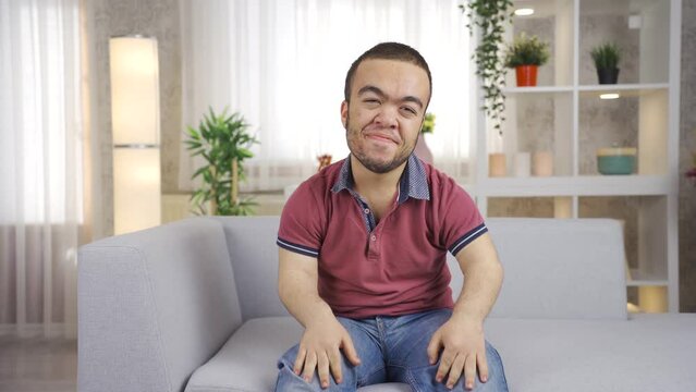 Cute and cheerful young dwarf man looking at camera giving motivation
Young man with dwarfism looking at camera giving his audience motivation and pep talk, support.
