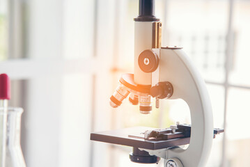 Science microscope equipment in biology chemical laboratory. Scientific experiment Microscope on Lab table microbiology equipment. Chemistry objects on lab background. Chemistry scientific concept