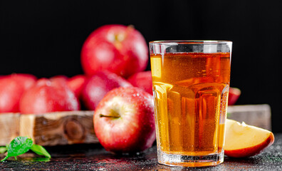 Fresh homemade apple juice. On a black background.