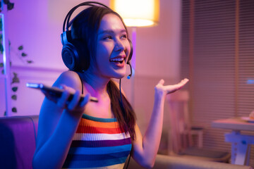 Asian young beautiful  woman streamer listening to music dancing and listening music at Home Interior, Residential Building.