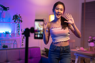 Asian young beautiful  woman streamer listening to music dancing and listening music at Home Interior, Residential Building.