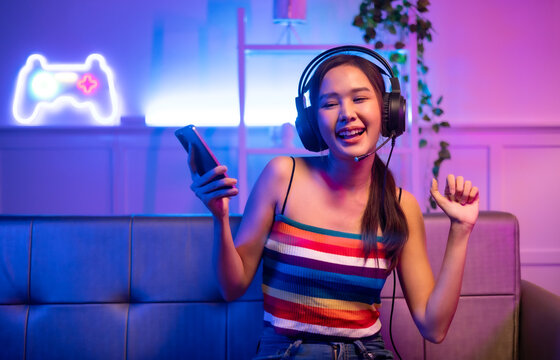 Asian young beautiful  woman streamer listening to music dancing and listening music at Home Interior, Residential Building.