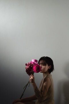 マゼンダ色の花束を持った女性のポートレート
