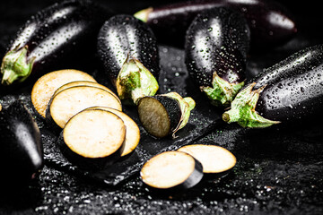 Pieces of ripe eggplant on a stone board. 