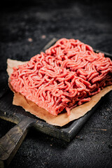 A piece of raw minced meat on a cutting board. 