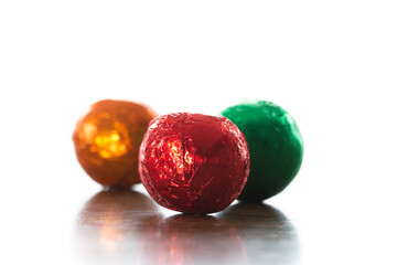 Fototapeta na wymiar Close-up, macro image of foil-wrapped chocolate Christmas balls 