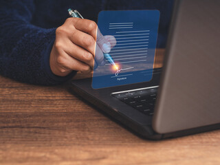 Businesswoman using a pen to sign an electronic digital document on a virtual screen