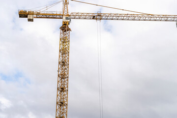 Construction site with cranes against blue sky. Industrial background. Modern skyscrapers. Unfinished construction