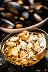 Fototapeta premium Pickled mussels in a glass bowl with spices. 