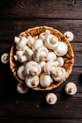 Basket with fresh mushrooms. On a wooden background. 