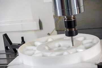 The  CNC milling machine cutting the nylon 6 material part with ball end mill tool.