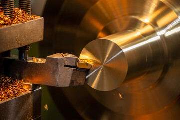 Closeup scene the lathe machine finish cut the brass parts by lathe tools.
