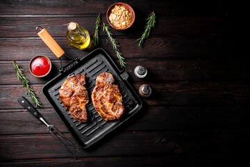 Grilled pork steak in a frying pan. 
