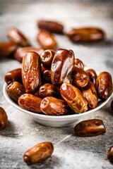 Full bowl with dates on the table. 