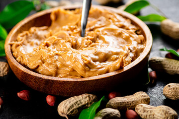 Peanut butter on a plate with a spoon.