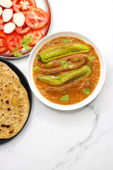 Mirchi or mirch ka Salan. Green chilly sabzi. It is a popular Indian chili and peanut curry from Hyderabad. Accompanies Hyderabadi mutton or chicken biryani. Copy space. 