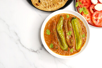 Mirchi or mirch ka Salan. Green chilly sabzi. It is a popular Indian chili and peanut curry from Hyderabad. Accompanies Hyderabadi mutton or chicken biryani. Copy space. 