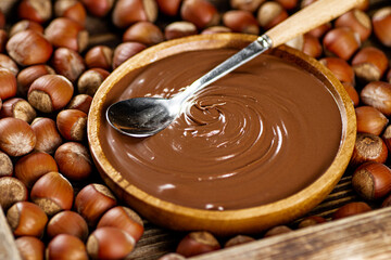 Hazelnut butter on a wooden plate. 
