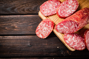 Sliced delicious salami sausage on the table. 