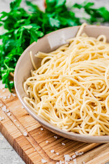 Boiled spaghetti in a plate with parsley. 