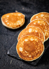 Ready made homemade pancakes on a stone board. 