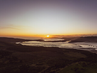 Fototapeta na wymiar Stunning aerial drone evening sunset view of Porpoise Bay and Curio Bay near Waikawa, part of the Catlins Coast, an area in the southeastern corner of New Zealand's South Island, Southland region.