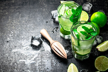 Traditional mojito with pieces of lime and mint. 