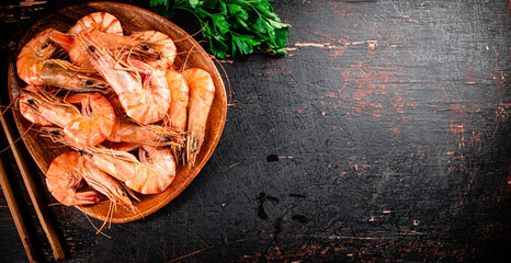 Cooked shrimp in a plate with parsley.