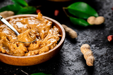 Peanut butter in a wooden plate. 