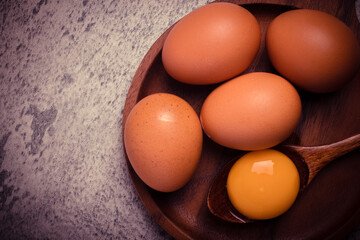 Fresh chicken eggs in a wooden plate