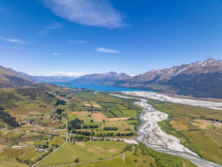 Beautiful high angle aerial view of Rees River, Dart River and the Glenorchy-Paradise Road with the town of Glenorchy and Lake Wakatipu in the background. Near Queenstown, South Island, New Zealand.